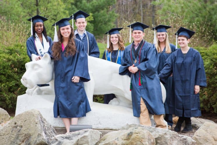 Group of Penn State students standing by lion statue