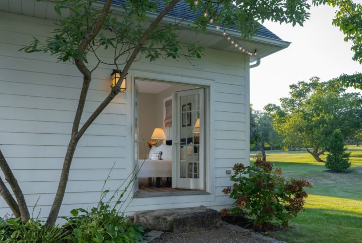 Exterior view of the property's private entrance to one of the bedrooms with the doors open to the room