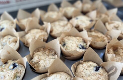 muffins in brown wrappers with blueberries, chocolate chips and zuchinni